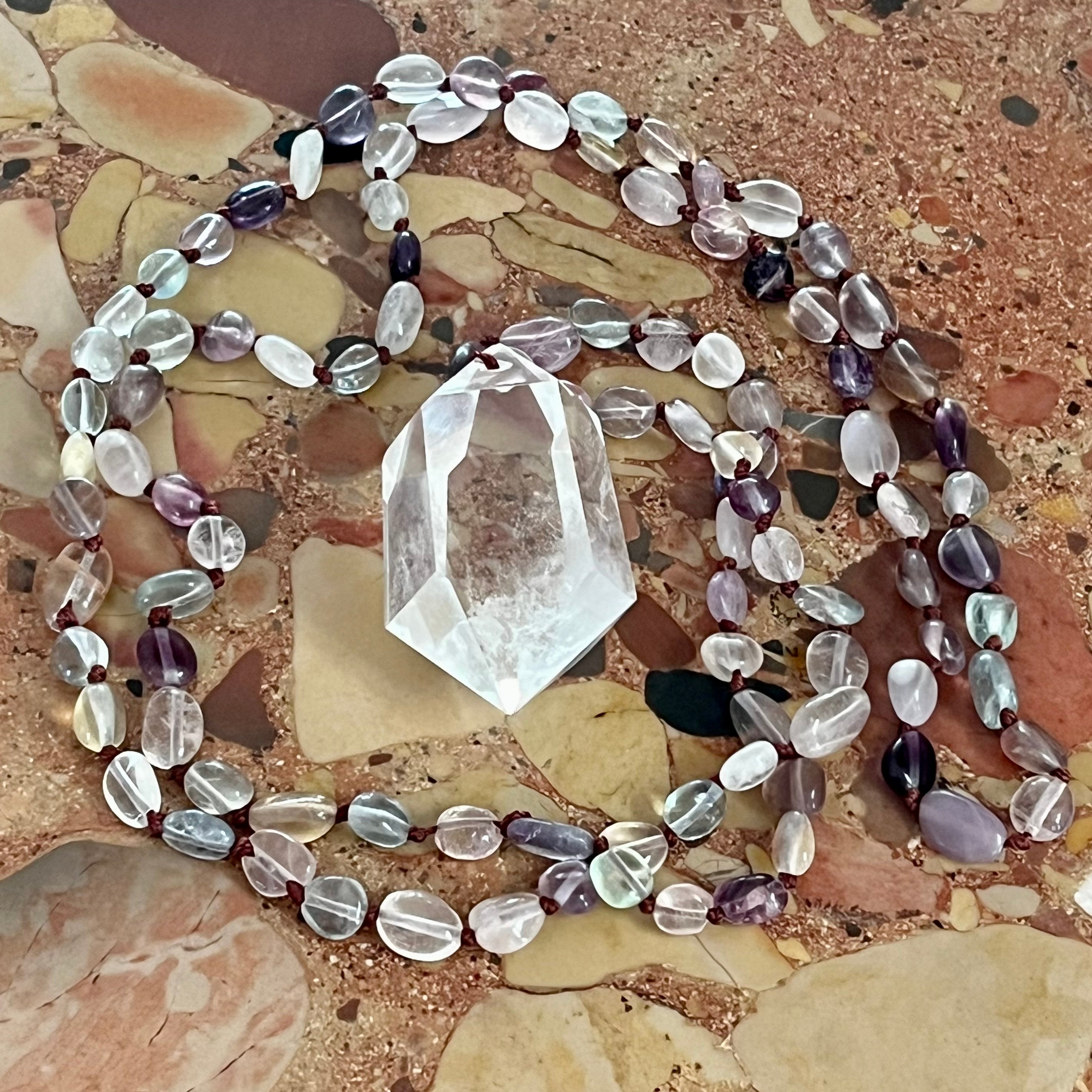 Hand-knotted necklace with fluorite and rock crystal tip