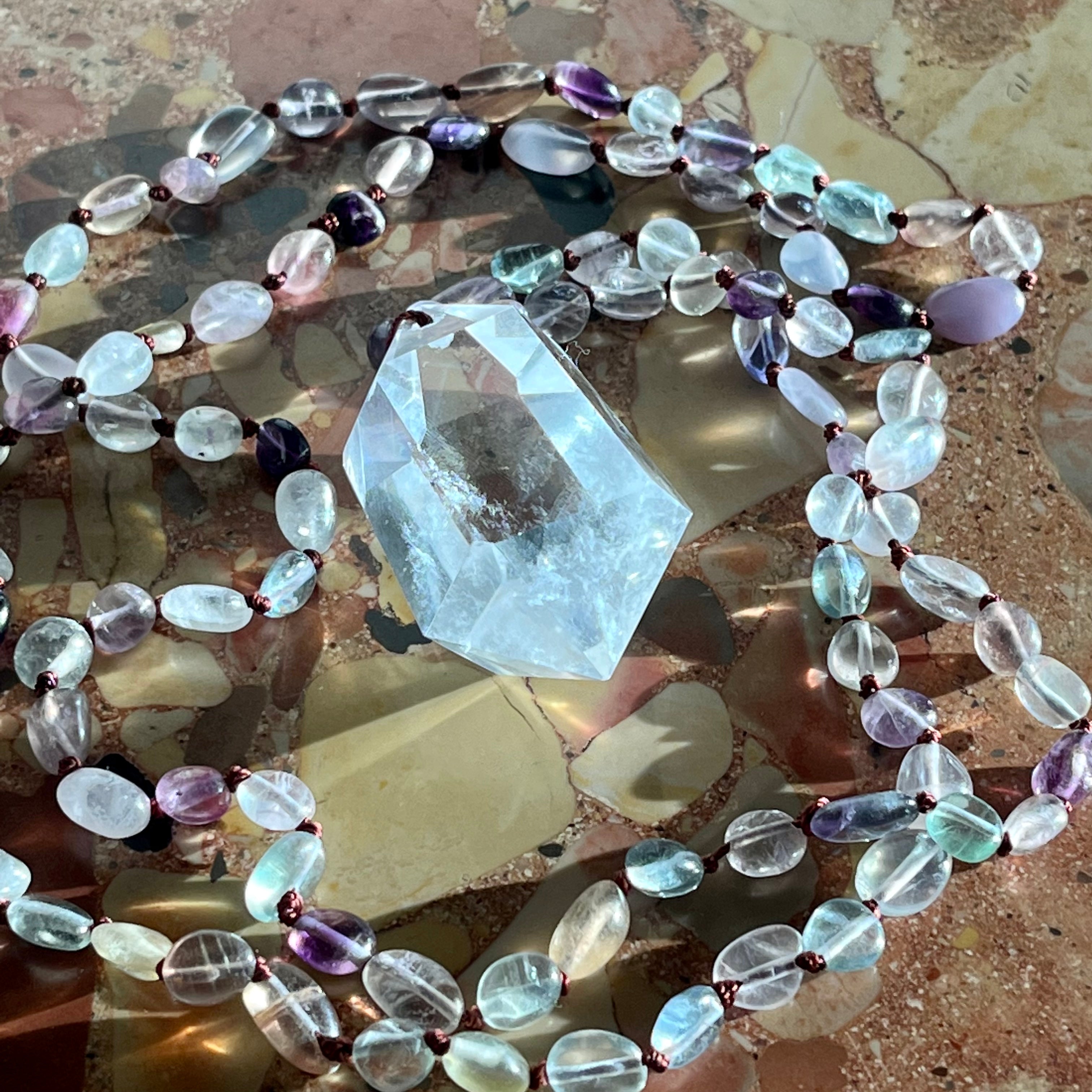 Hand-knotted necklace with fluorite and rock crystal tip