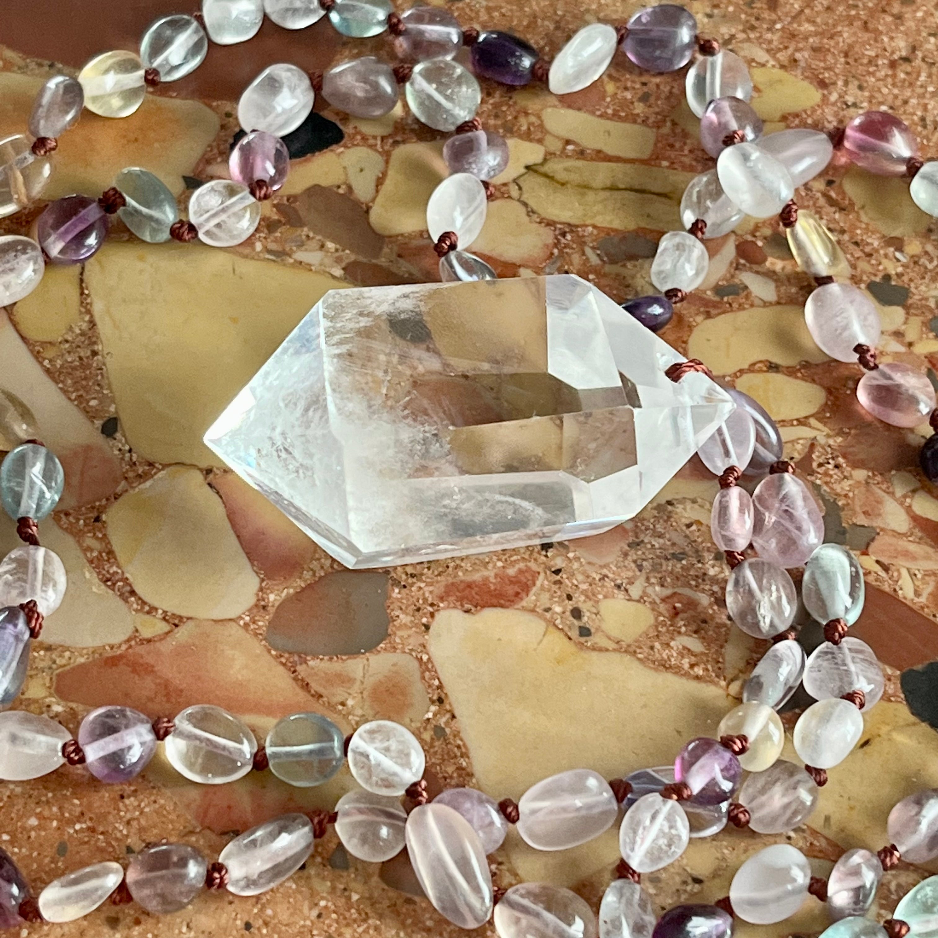 Hand-knotted necklace with fluorite and rock crystal tip