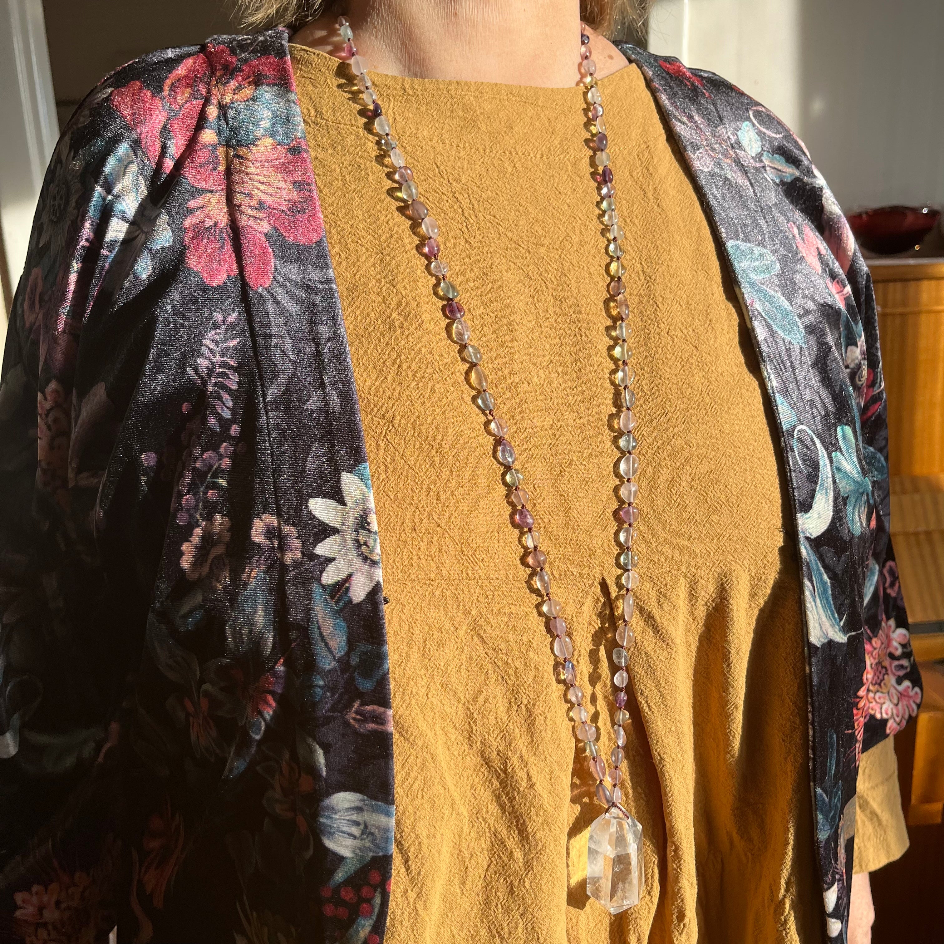 Hand-knotted necklace with fluorite and rock crystal tip