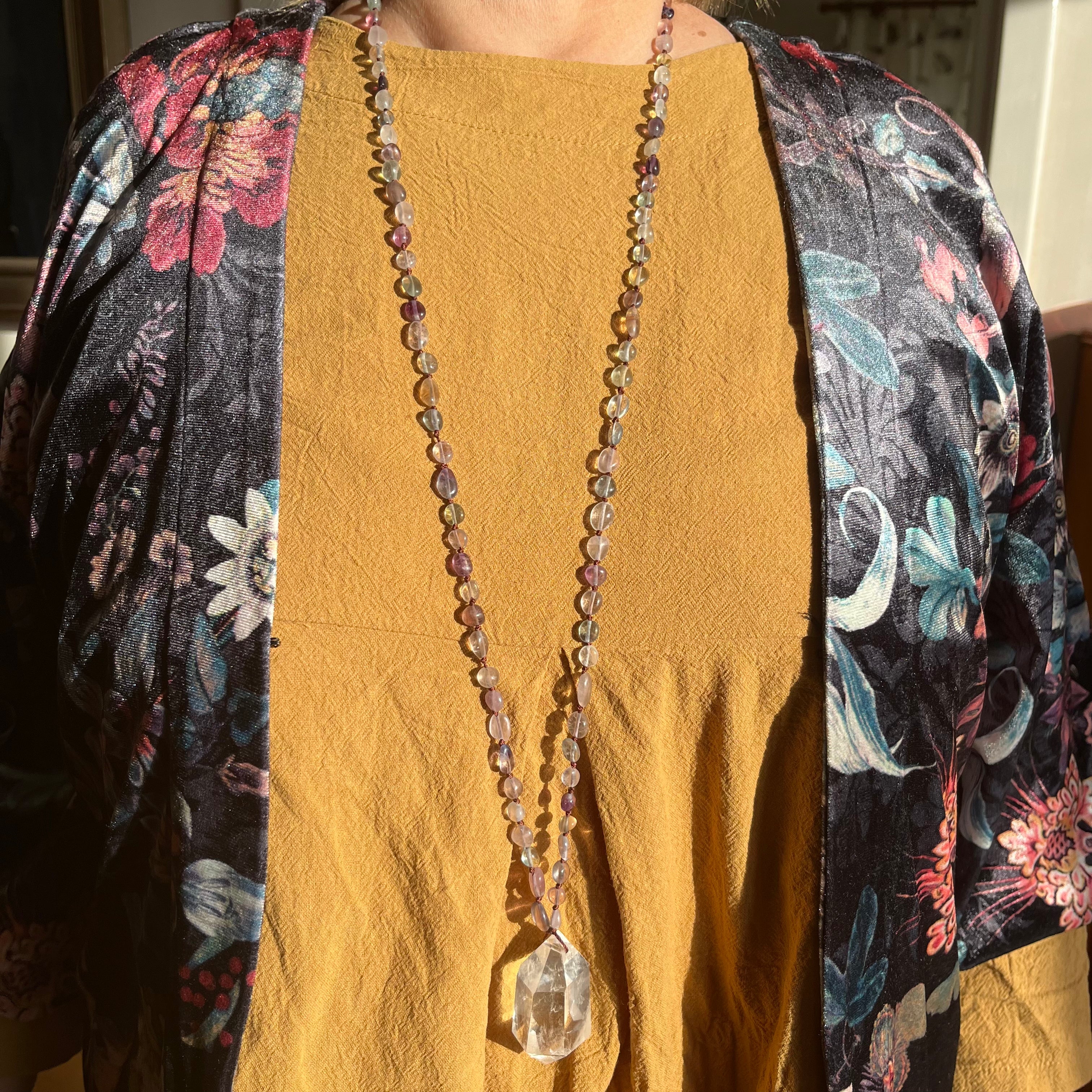 Hand-knotted necklace with fluorite and rock crystal tip